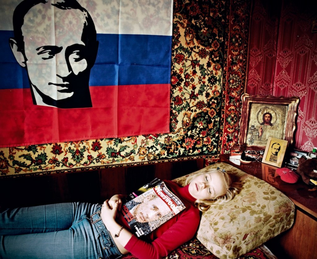 Tanya Arkhipova, I have two t-shirts, one for the protest at the Georgian Embassy with Bush and Saakashvili's portraits and words «All of them are puppets in crafty hands», a sweatshirt saying «I want to see… for the third term», a pin, a flag, a screensaver, many different postcards with his portrait. I like how Putin treats his children and wife, I think he's a great husband. He made people respect Russia, I can tell by my parents. Life is more stable, the pensions and allowances are rising, there's development. "